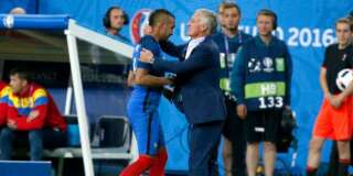 France coach Didier Deschamps hugs France's Dimitri Payet, left, as he leaves the pitch after being substituted during the Euro 2016 Group A soccer match between France and Romania, at the Stade de France, in Saint-Denis, north of Paris, Friday, June 10, 2016. (AP Photo/Thibault Camus)