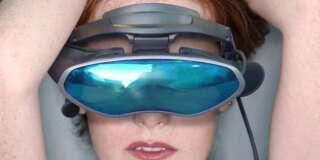 Nude woman wearing virtual reality goggles