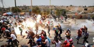 Des Palestiniens courent après des tirs de gaz lacrymogènes de la police israélienne après la prière vendredi 21 juillet, dans la vieille ville de Jérusalem.
