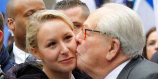 Marion Marechal-Le Pen, left, niece of far-right National Front party leader Marine Le Pen, receives a kisses from her grandfather, former leader and honorary president of the National Front party Jean-Marie Le Pen during the traditional May Day march in Paris, Wednesday May 1, 2013. (AP Photo/Jacques Brinon)