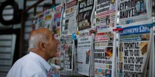 A man looks at the newspapers at a newsstand in central Athens, Monday, July 6, 2015. Greeceâs finance minister has resigned following Sundayâs referendum in which the majority of voters said ânoâ to more austerity measures in exchange for another financial bailout. (AP Photo/Emilio Morenatti)