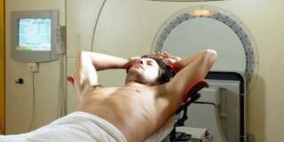 Young male patient lying on radiology bed