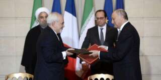 French Foreign Minister Laurent Fabius (R), his Iranian counterpart Mohammad Javad Zarif (L), Iran's President Hassan Rouhani (L Rear) and French President Francois Hollande attend a contracts and economic agreements signing ceremony at the Elysee Palace in Paris, France, January 28, 2016.    REUTERS/Stephane De Sakutin/Pool