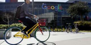 A cyclist rides past Google Inc. offices inside the Googleplex headquarters in Mountain View, California, U.S., on Thursday, Feb. 18, 2016. Google, part of Alphabet Inc., plans on tapping into existing fiber networks in San Francisco to deliver ultra-fast internet access across the city. Photographer: Michael Short/Bloomberg via Getty Images