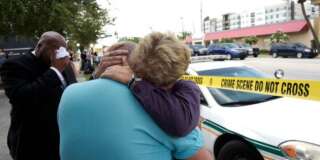 Terry DeCarlo, executive director of the LGBT Center of Central Florida, center, is comforted by Orlando City Commissioner Patty Sheehan, right, after a shooting involving multiple fatalities at a nightclub in Orlando, Fla., Sunday, June 12, 2016. (AP Photo/Phelan M. Ebenhack)