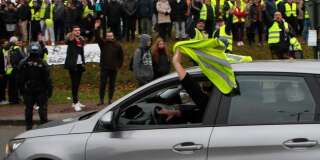 Un conducteur brandit un gilet jaune pour afficher son soutien au mouvement le 15 janvier 2019 à Grand Bourgtheroulde en Normandie.