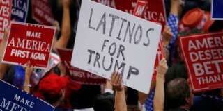 A person holds a sign reading 'Latinos for Trump' on the third day of the Republican National Convention in Cleveland, Ohio, U.S. July 20, 2016. REUTERS/Carlo Allegri