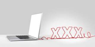 Laptop computer with a red ethernet cable forming 'XXX', coming out of the back on a plain background