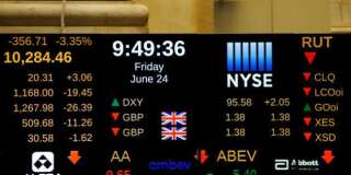 A board above the floor of the New York Stock Exchange (NYSE) shows the current standing of the British Pound sterling in New York, U.S., June 24, 2016.  REUTERS/Lucas Jackson