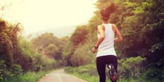 young fitness woman runner  running at forest trail