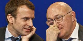 French Economy Minister Emmanuel Macron, left, and French Finance Minister Michel Sapin attend a joint media conference during the French German economic summit at the finance ministry in Paris, Tuesday, Feb. 9, 2016. (AP Photo/Michel Euler)
