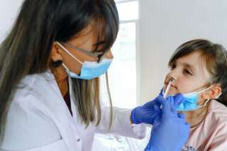 Little girl getting a nasal vaccine
