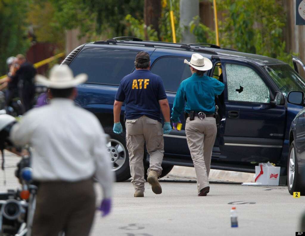 - ATF and other investigators walk near a vehicle which was struck by a bullet near the scene where a gunman opened fire near the Texas A&M university on Monday, Aug. 13, 2012, in College Station, Texas. A Texas law enforcement officer attacked as he brought an eviction notice to a house Monday was among three people, including a shooter inside the home, killed Monday near a Texas university. (AP Photo/Houston Chronicle, Mayra Beltran)