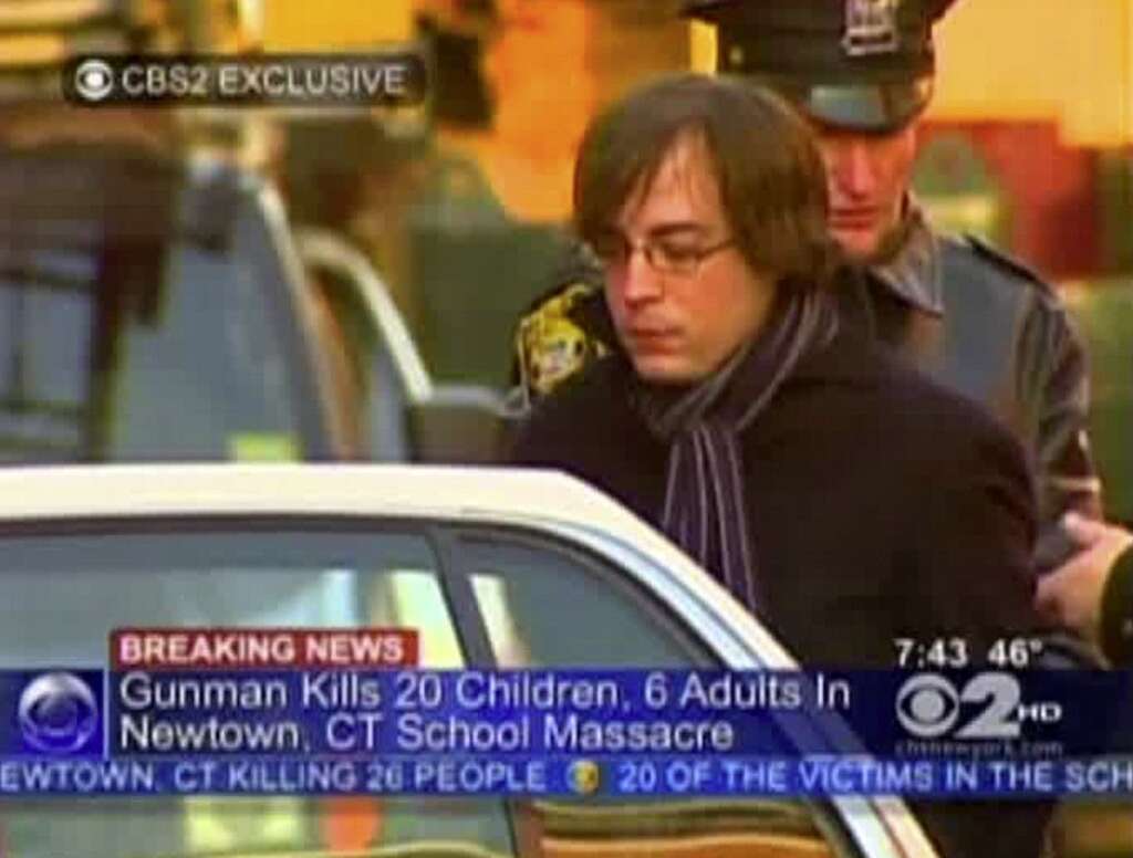Sandy Hook Elementary School Shooting - In this frame grab provided by WCBS in New York, Ryan Lanza, the 24-year-old brother of Sandy Hook Elementary School shooter Adam Lanza, is escorted by police into a cruiser in Hoboken, N.J., Friday, Dec. 14, 2012. Adam Lanza, 20, killed his mother at home and then opened fire Friday inside the elementary school massacring 26 people, including 20 children, as youngsters cowered in fear to the sound of gunshots echoing through the building and screams coming over the intercom. (AP Photo/WCBS-TV)
