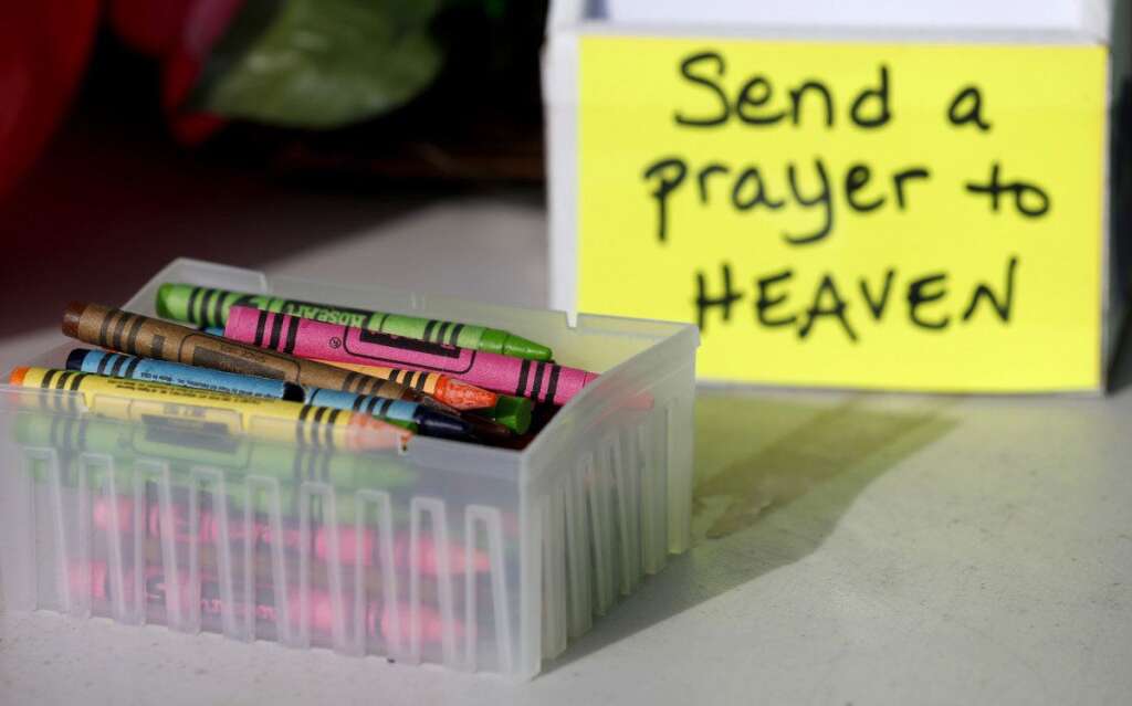 - Crayons sit on a table outside of a barbershop a day after a gunman opened fire at Sandy Hook Elementary School, Saturday, Dec. 15, 2012, in the Sandy Hook village of Newtown, Conn. The massacre of 26 children and adults at Sandy Hook Elementary school elicited horror and soul-searching around the world even as it raised more basic questions about why the gunman, 20-year-old Adam Lanza, would have been driven to such a crime and how he chose his victims. (AP Photo/Julio Cortez)