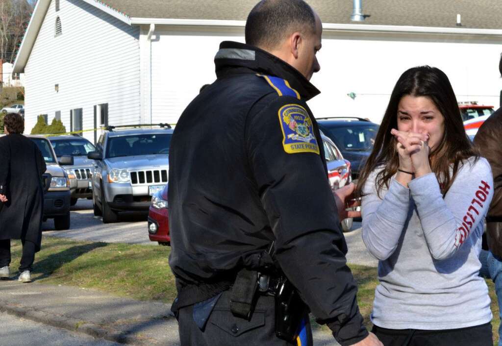 Sandy Hook Elementary School Shooting - A woman waits to hear about her sister, a teacher, following a shooting at the Sandy Hook Elementary School in Newtown, Conn., about 60 miles (96 kilometers) northeast of New York City, Friday, Dec. 14, 2012. A gunman entered the school Friday morning and killed at least 26 people, including 20 young children. (AP Photo/The New Haven Register, Melanie Stengel)