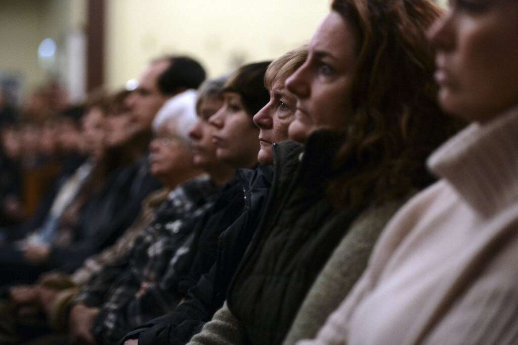 Sandy Hook Elementary School Shooting - Mourners gather inside the St. Rose of Lima Roman Catholic Church at a vigil service for victims of the Sandy Hook Elementary School shooting that left at least 27 people dead, many of them young children, in Newtown, Conn. Friday, Dec. 14, 2012. Police have identified the gunman as Adam Lanza. (AP Photo/Andrew Gombert, Pool)