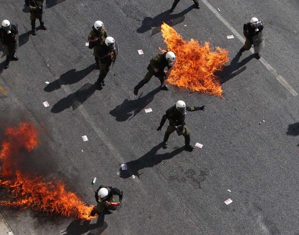 - Protesters throw petrol bombs at riot police officers during a 24-hour nationwide general strike, Athens, Thursday, Oct. 18, 2012. Greece was facing its second general strike in a month Thursday as workers protested over another batch of austerity measures that are designed to prevent the bankruptcy of the country. (AP Photo/Thanassis Stavrakis)