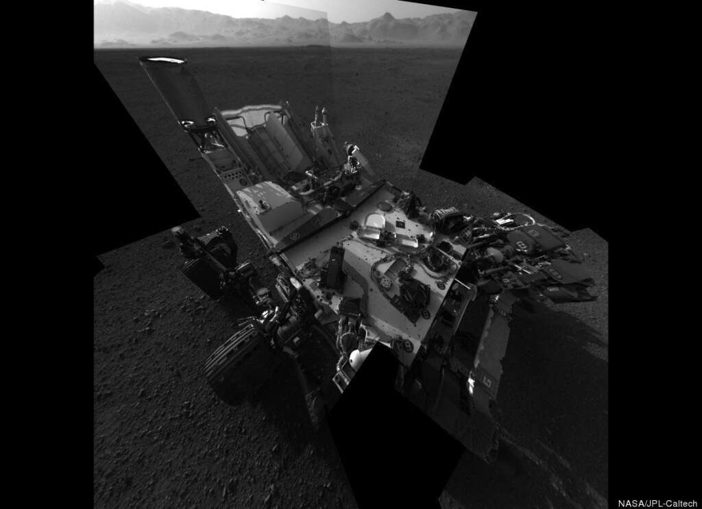 'Still Life with Rover' - This full-resolution self-portrait shows the deck of NASA's Curiosity rover from the rover's Navigation camera. The back of the rover can be seen at the top left of the image, and two of the rover's right side wheels can be seen on the left. The undulating rim of Gale Crater forms the lighter color strip in the background. Bits of gravel, about 0.4 inches (1 centimeter) in size, are visible on the deck of the rover.     This mosaic is made of 20 images, each of 1,024 by 1,024 pixels, taken late at night on Aug. 7 PDT (early morning Aug. 8 EDT). It uses an average of the Navcam positions to synthesize the point of view of a single camera, with a field of view of 120 degrees. Seams between the images have been minimized as much as possible. The wide field of view introduces some distortion at the edges of the mosaic. (NASA)