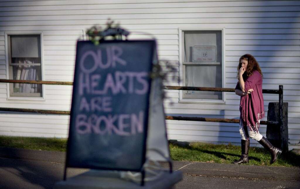 Tamara Doherty - Shop owner Tamara Doherty, paces outside her store just down the road from Sandy Hook Elementary School, Saturday, Dec. 15, 2012, in Newtown, Conn. The massacre of 26 children and adults at Sandy Hook Elementary school elicited horror and soul-searching around the world even as it raised more basic questions about why the gunman, 20-year-old Adam Lanza, would have been driven to such a crime and how he chose his victims. (AP Photo/David Goldman)