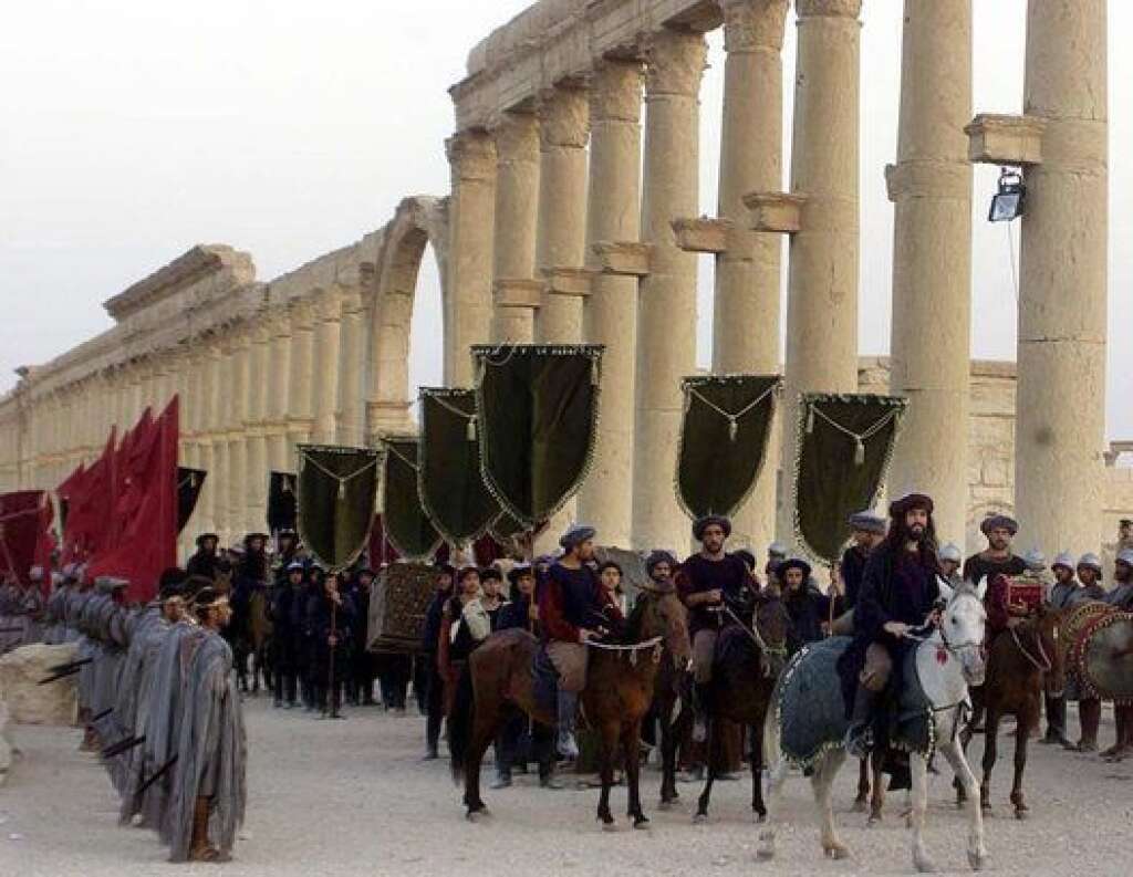 Mideast Syria Palmyra - FILE - In this Sept. 27, 2002, file photo, a symbolic trade caravan representing the prosperous trade during the era of Queen Zanobya 260-273AD attend a show held in the ancient city of Palmyra, some 240 kilometers (150 miles) northeast of Damascus, Syria. A Syrian official said on Sunday that the situation is "fully under control" in Palmyra despite breaches by Islamic State militants who pushed into the historic town a day earlier. (AP Photo/Bassem Tellawi, File)