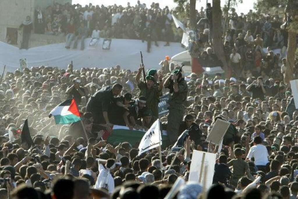 Les funérailles de Yasser Arafat - "Avec notre sang et notre âme nous nous sacrifions pour toi Abou Ammar", clame la foule qui agite des drapeaux aux couleurs de la Palestine. Une immense banderole avec le portrait du "raïs" est tendue dans la Mouqataa.