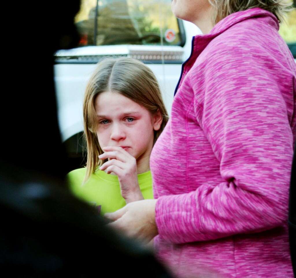 Sandy Hook Elementary School Shooting - A young girl cries following a shooting at the Sandy Hook Elementary School in Newtown, Conn., about 60 miles (96 kilometers) northeast of New York City, Friday, Dec. 14, 2012. A gunman entered the school Friday morning and killed at least 26 people, including 20 young children. (AP Photo/The New Haven Register, Melanie Stengel)