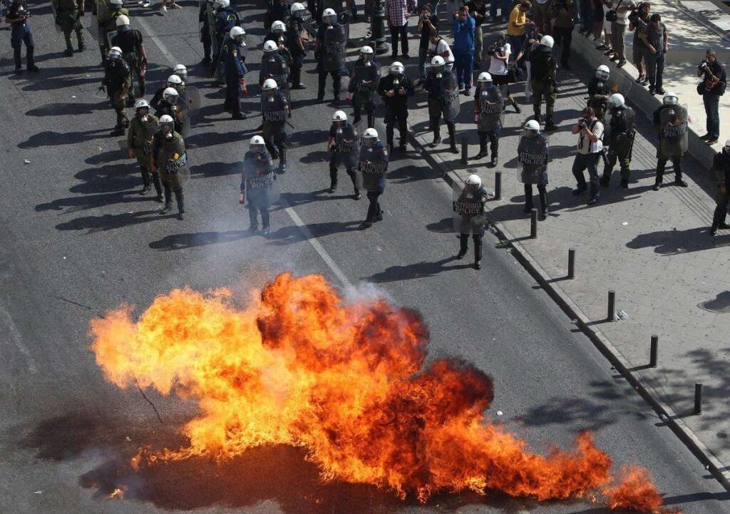 - Protesters throw petrol bombs against riot police during a 24-hour nationwide general strike, Athens, Thursday, Oct. 18, 2012. Greece was facing its second general strike in a month Thursday as workers protested over another batch of austerity measures that are designed to prevent the bankruptcy of the country. (AP Photo/Thanassis Stavrakis)