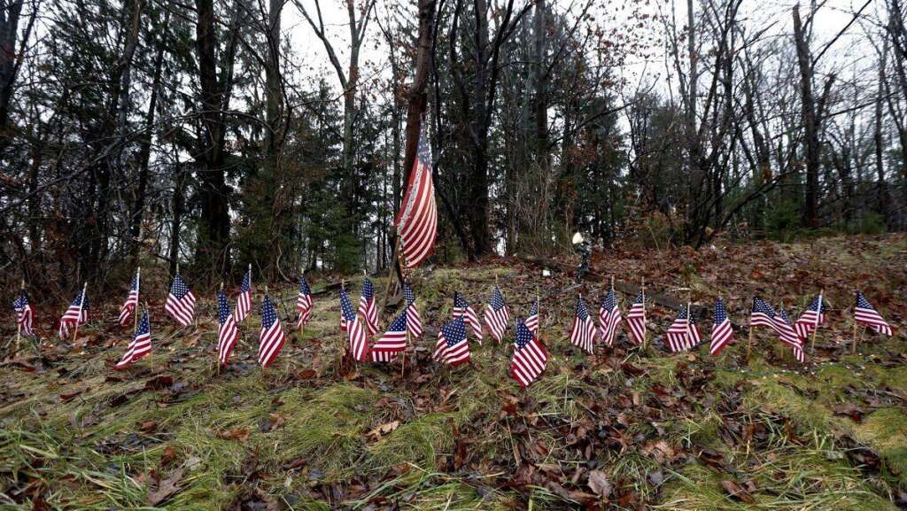 - Twenty-seven small U.S. flags adorn a large flag on a makeshift memorial on the side of Highway 84 near the Newtown, Conn., town line as residents mourn victims killed by gunman Adam Lanza, Monday, Dec. 17, 2012. On Friday, authorities say Lanza killed his mother at their home and then opened fire inside the Sandy Hook Elementary School in Newtown, killing 26 people, including 20 children, before taking his own life. (AP Photo/Julio Cortez)