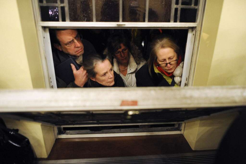 Sandy Hook Elementary School Shooting - Mourners look in from outside during a vigil service for victims of the Sandy Hook Elementary School shooting, at the St. Rose of Lima Roman Catholic Church in Newtown, Conn. Friday, Dec. 14, 2012. A man killed his mother at their home and then opened fire Friday inside Sandy Hook Elementary School, massacring 26 people, including 20 children, as youngsters cowered in fear to the sound of gunshots reverberating through the building and screams echoing over the intercom (AP Photo/Andrew Gombert, Pool)