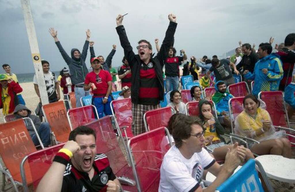 Brazil Soccer WCup Germany - Germany soccer fans celebrate their team's first goal against Brazil as they watch the World Cup semifinal match via live telecast on Copacabana beach in Rio de Janeiro, Brazil, Tuesday, July 8, 2014. (AP Photo/Silvia Izquierdo)