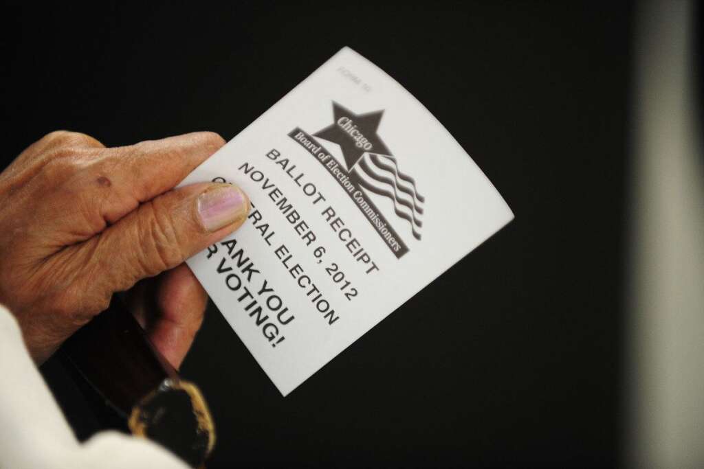 US-VOTE-2012-ELECTION - A elderly woman holds her voting receipt after voting  at a polling station in a senior appartment complex in Chicago, Illinois in the US presidential election November 6, 2012 .  The final national polls showed an effective tie, with either US President Barack Obama or Republican challenger Mitt Romney favored by a single point in most surveys, reflecting the polarized politics of a deeply divided nation.  AFP PHOTO / Robyn Beck        (Photo credit should read ROBYN BECK/AFP/Getty Images)