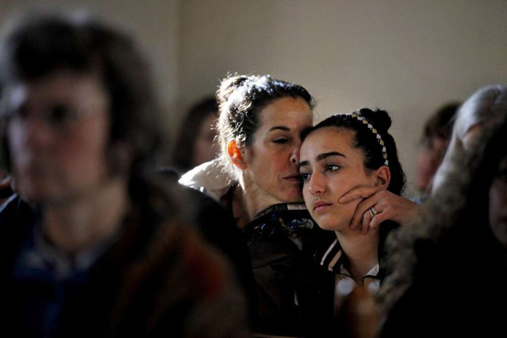 Sandy Hook Elementary School Shooting - Elizabeth Bogdanoff, left, kisses her daughter Julia, 13, both of Newtown, Conn., during a prayer service at St John's Episcopal Church, Saturday, Dec. 15, 2012, in Newtown, Conn. The massacre of 26 children and adults at Sandy Hook Elementary school elicited horror and soul-searching around the world even as it raised more basic questions about why the gunman, 20-year-old Adam Lanza, would have been driven to such a crime and how he chose his victims. (AP Photo/David Goldman)
