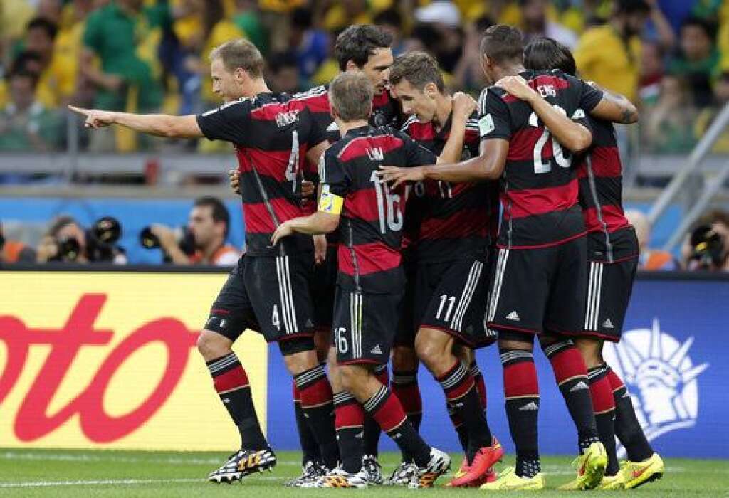 Brazil Soccer WCup Brazil Germany - Germany players celebrate after scoring during the World Cup semifinal soccer match between Brazil and Germany at the Mineirao Stadium in Belo Horizonte, Brazil, Tuesday, July 8, 2014. (AP Photo/Frank Augstein)