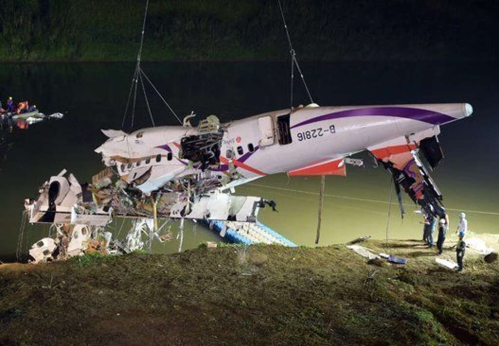 Rescuers lift the wreckage of the TransAsia ATR 72-600 out of the Keelung river at New Taipei City on February 4, 2015.  At least 23 people were killed when a passenger plane operated by TransAsia Airways clipped an overpass soon after take-off and plunged into a river in Taiwan, the airline's second crash in seven months.   AFP PHOTO / SAM YEH        (Photo credit should read SAM YEH/AFP/Getty Images)