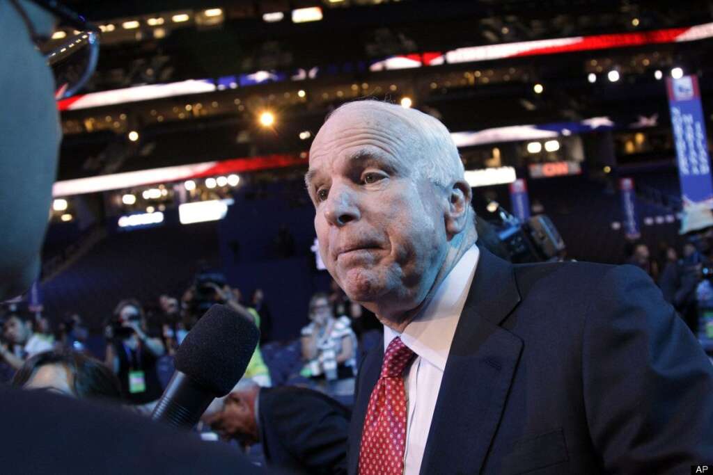 John McCain - A reporter, left, tries to interview Sen. John McCain, R-Ariz., as he walks the floor of the Republican National Convention, Wednesday, Aug. 29, 2012, in Tampa, Fla. (AP Photo/Mary Altaffer)