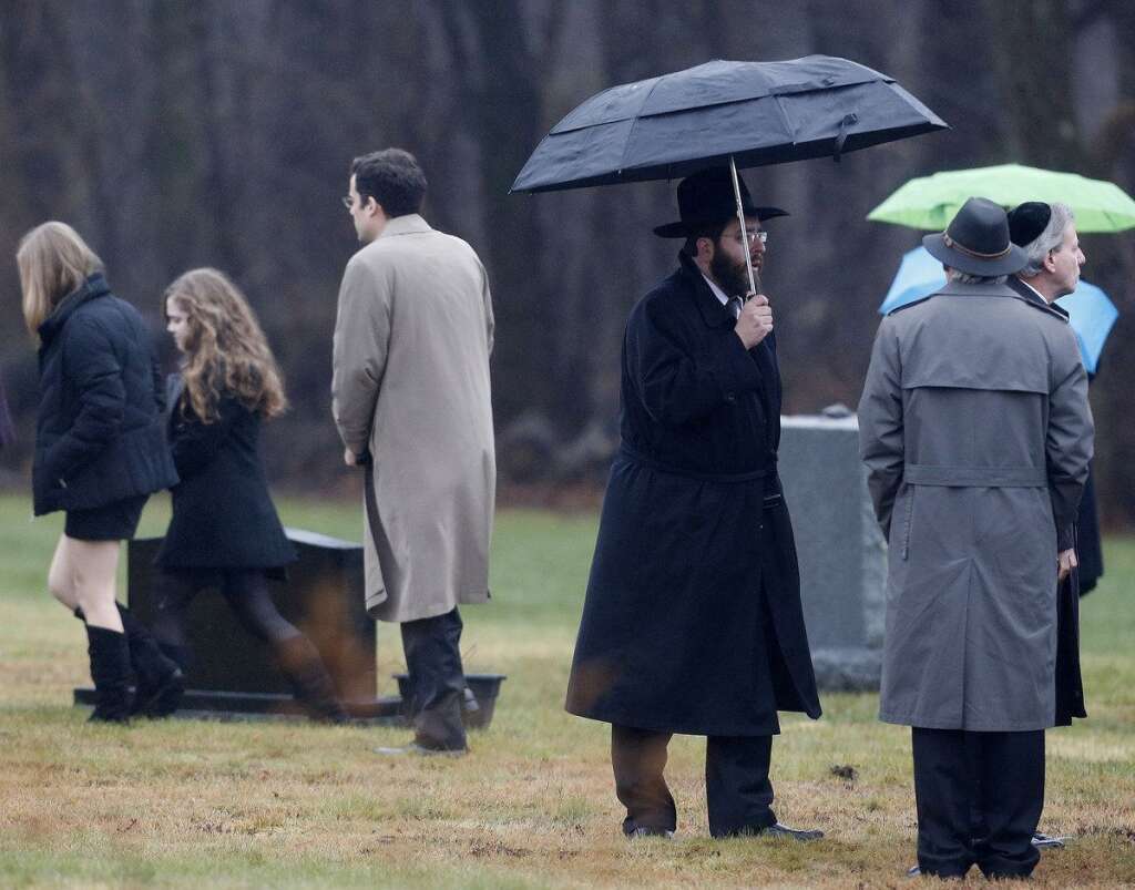 - People arrive at B'nai Israel Cemetery during burial services for Noah Pozner, a six-year-old killed in the Sandy Hook Elementary School shooting, Monday, Dec. 17, 2012, in Monroe, Conn. Authorities say gunman Adam Lanza killed his mother at their home on Friday and then opened fire inside the Sandy Hook Elementary School in Newtown, killing 26 people, including 20 children, before taking his own life. (AP Photo/Julio Cortez)