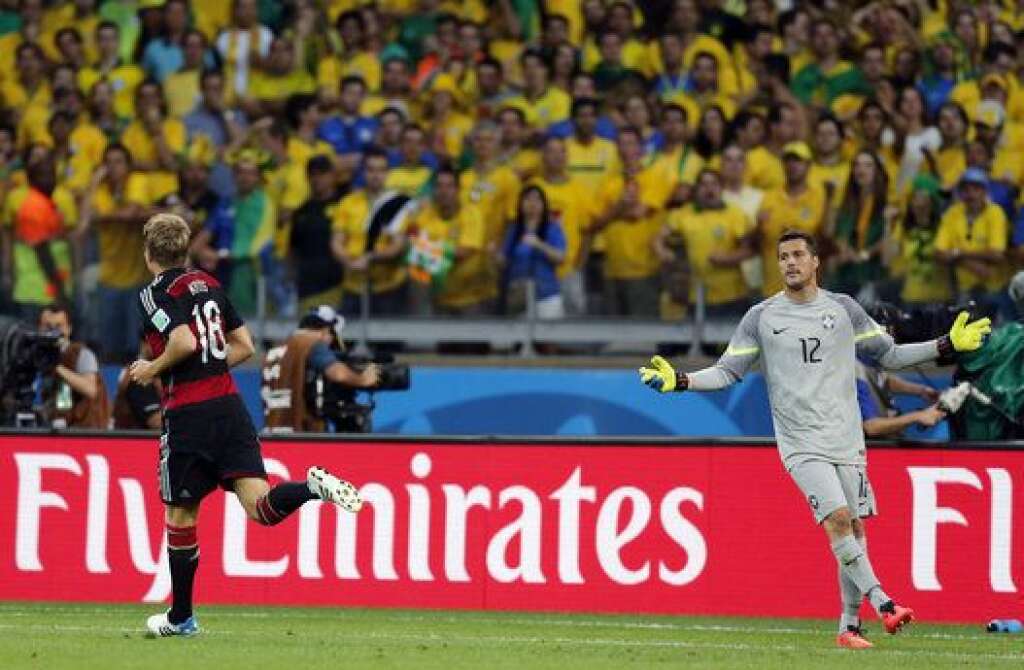 Brazil Soccer WCup Brazil Germany - Brazil's goalkeeper Julio Cesar, right, reacts after Germany's Toni Kroos, left, scored during the World Cup semifinal soccer match between Brazil and Germany at the Mineirao Stadium in Belo Horizonte, Brazil, Tuesday, July 8, 2014. (AP Photo/Frank Augstein)