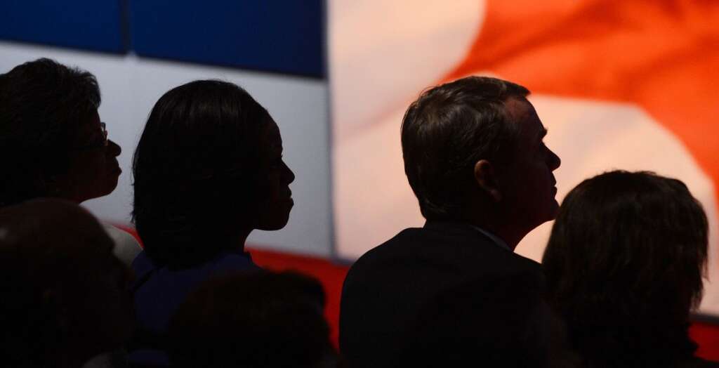 US-VOTE-2012-DEBATE - US First Lady Michelle Obama (2nd-L) listens as US President Barack Obama and Republican presidential candidate Mitt Romney participate in the first presidential debate at Magness Arena at the University of Denver in Denver, Colorado, October 3, 2012, moderated by Jim Lehrer of the PBS NewsHour. After hundreds of campaign stops, $500 million in mostly negative ads and countless tit-for-tat attacks,  Obama and Romney go head-to-head in their debut debate.    AFP PHOTO / Saul LOEB        (Photo credit should read SAUL LOEB/AFP/GettyImages)