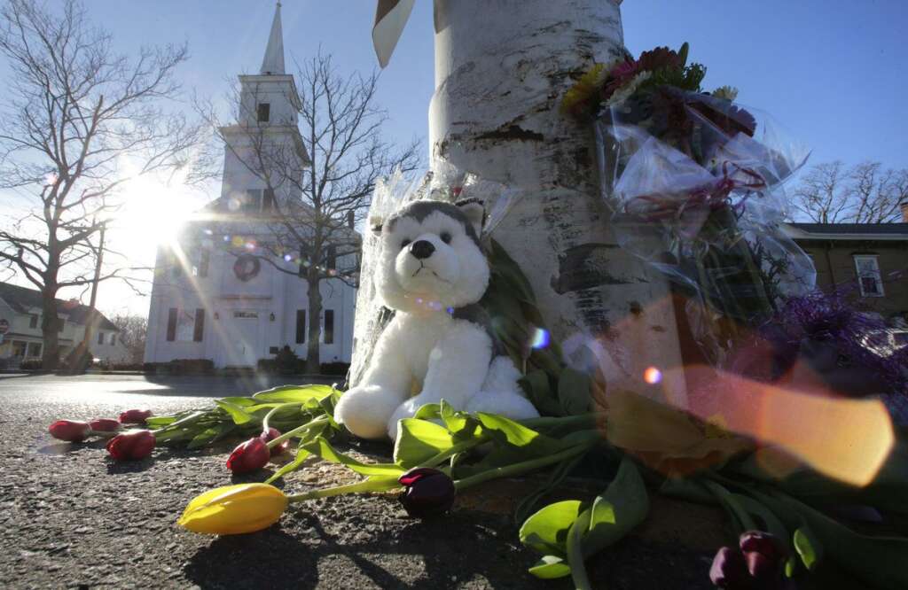 Sandy Hook Elementary School Shooting - Flowers and stuffed animals of a makeshift memorial for school shooting victims encircle the flagpole at the town center in Newtown, Conn., Saturday, Dec. 15, 2012. The massacre of 26 children and adults at Sandy Hook Elementary school elicited horror and soul-searching around the world even as it raised more basic questions about why the gunman, 20-year-old Adam Lanza, would have been driven to such a crime and how he chose his victims. (AP Photo/Charles Krupa)