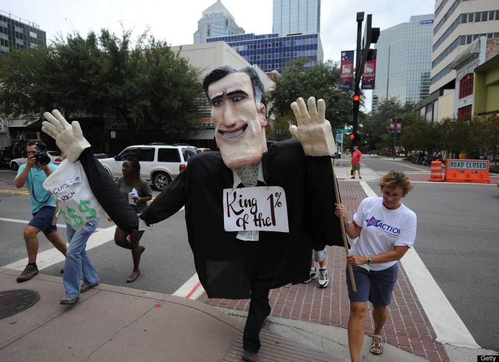 US-VOTE-2012-REPUBLICAN CONVENTION - Anti-Mitt Romney protesters march through the streets in Tampa, Florida, on August 26, 2012 ahead of the Republican National Convention. The 2012 Republican National Convention was scheduled to be held at the Tampa Bay Times Forum from August 27-30, 2012,  but was cut short by one day due to incoming severe weather and possible hurricane conditions. AFP PHOTO Robyn BECK        (Photo credit should read ROBYN BECK/AFP/GettyImages)