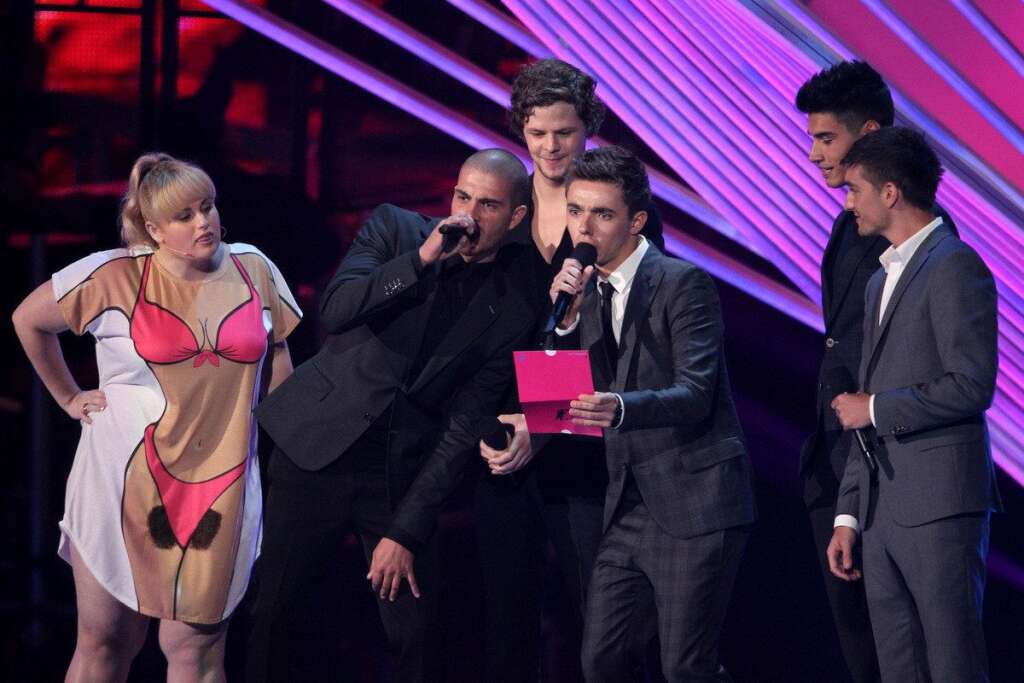 Rebel Wilson, Max George, Jay McGuiness, Nathan Sykes, Siva Kaneswaran, Tom Parker - From left, Rebel Wilson and Max George, Jay McGuiness, Nathan Sykes, Siva Kaneswaran and Tom Parker, of musical group The Wanted, present an award onstage at the MTV Video Music Awards on Thursday, Sept. 6, 2012, in Los Angeles. (Photo by Matt Sayles/Invision/AP)