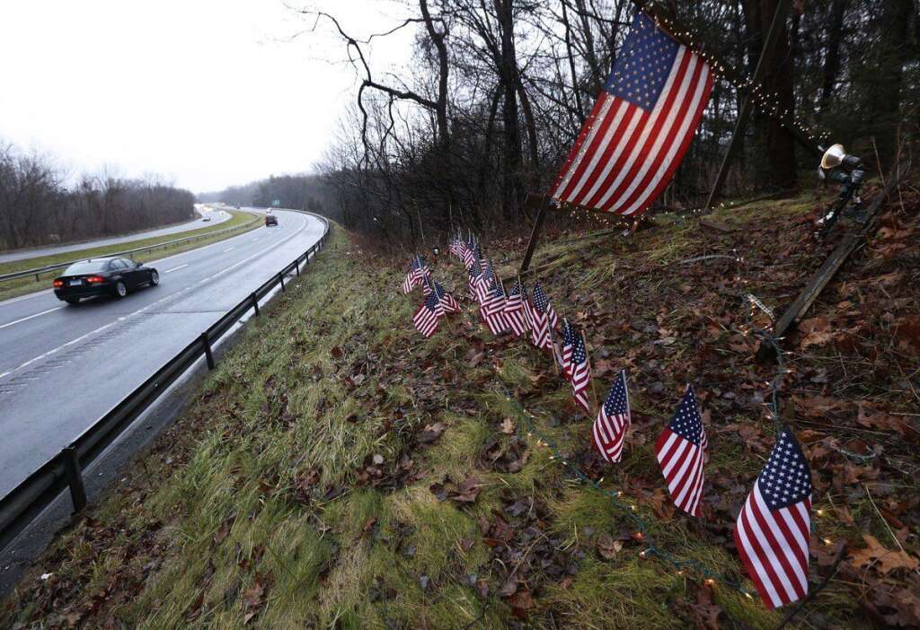 - Twenty-seven small U.S. flags adorn a large flag on a makeshift memorial on the side of Highway 84 near the Newtown, Conn., town line as residents mourn victims killed by gunman Adam Lanza, Monday, Dec. 17, 2012. Authorities say Lanza killed his mother at their home and then opened fire inside the Sandy Hook Elementary School in Newtown, killing 26 people, including 20 children, before taking his own life, on Friday. (AP Photo/Julio Cortez)