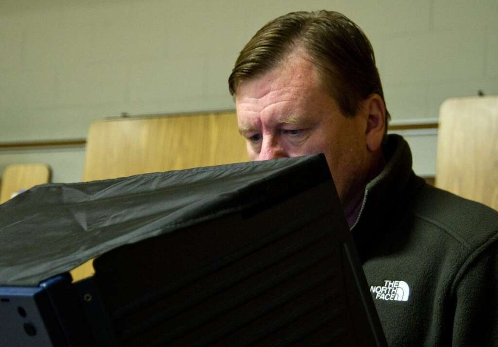 US-VOTE-2012-ELECTION-VOTERS - A man casts his ballot at the Stonewall Middle School November 6, 2012 in Manassas, Prince William County, Virginia. After a long and bitter White House campaign, Americans began casting their votes on Tuesday with polls showing President Barack Obama and Republican challenger Mitt Romney neck-and-neck in an election that will be decided in a handful of states. AFP PHOTO/Karen BLEIER        (Photo credit should read KAREN BLEIER/AFP/Getty Images)