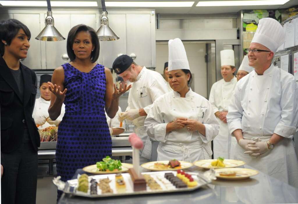 Michelle Obama fait la promotion des légumes - CE QU'ELLE AIME: En guerre contre l'obésité, la First Lady se bat au quotidien pour imposer les légumes dans l'alimentation des enfants. Après avoir fait pousser un potager bio à la Maison Blanche, lancé sa campagne "Let's move" en faveur du sport, Michelle Obama a cosigné un livre de recettes à base de légumes avec la chef cuisinière de la résidence présidentielle, Cristeta Comerford (à droite).    CE QU'ELLE N'AIME PAS: Pas très fan de sucreries, Michelle Obama a tout de même sacrifié au traditionnel concours de cookies qui l'oppose à Ann Romney, dans le cadre de la présidentielle.