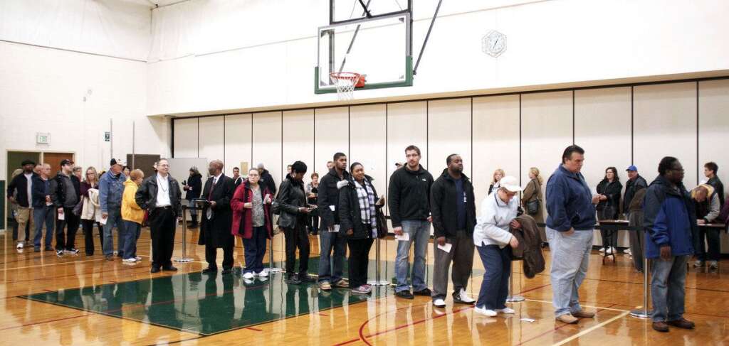 U.S. Citizens Head To The Polls To Vote In Presidential Election - STERLING HEIGHTS, MI, - NOVEMBER 6: U.S. citizens wait in line at a school gymnasium to vote in the presidential election at Carleton Middle School November 6, 2012 in Sterling Heights, Michigan. Recent polls show that U.S. President Barack Obama and Republican presidential candidate Mitt Romney are in a tight race. (Photo by Bill Pugliano/Getty Images)
