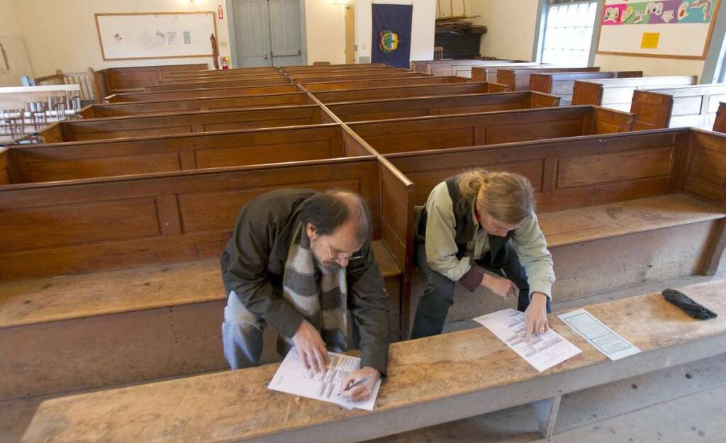 - James Ventresca, left, and Claudia Welch fill out their ballots at Town Hall on Election Day, Tuesday, Nov. 6, 2012 in Calais, Vt. (AP Photo/Toby Talbot)