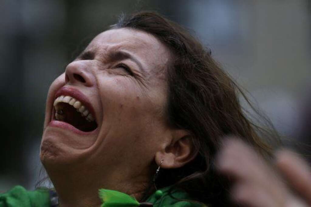 Brazil Soccer WCup Brazil Germany - A Brazilian soccer fan cries as she watches a live telecast of the semifinals World Cup soccer match between Brazil and Germany in Belo Horizonte, Brazil, Tuesday, July 08, 2014. (AP Photo/Bruno Magalhaes)