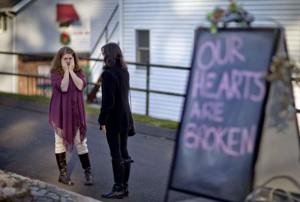 Tamara Doherty, Jackie Gaudet - Shop owners Tamara Doherty, left, and Jackie Gaudet, right, meet outside their stores for the first time since being neighbors, just down the road from Sandy Hook Elementary School, Saturday, Dec. 15, 2012, in Newtown, Conn. The massacre of 26 children and adults at Sandy Hook Elementary school elicited horror and soul-searching around the world even as it raised more basic questions about why the gunman, 20-year-old Adam Lanza, would have been driven to such a crime and how he chose his victims. (AP Photo/David Goldman)