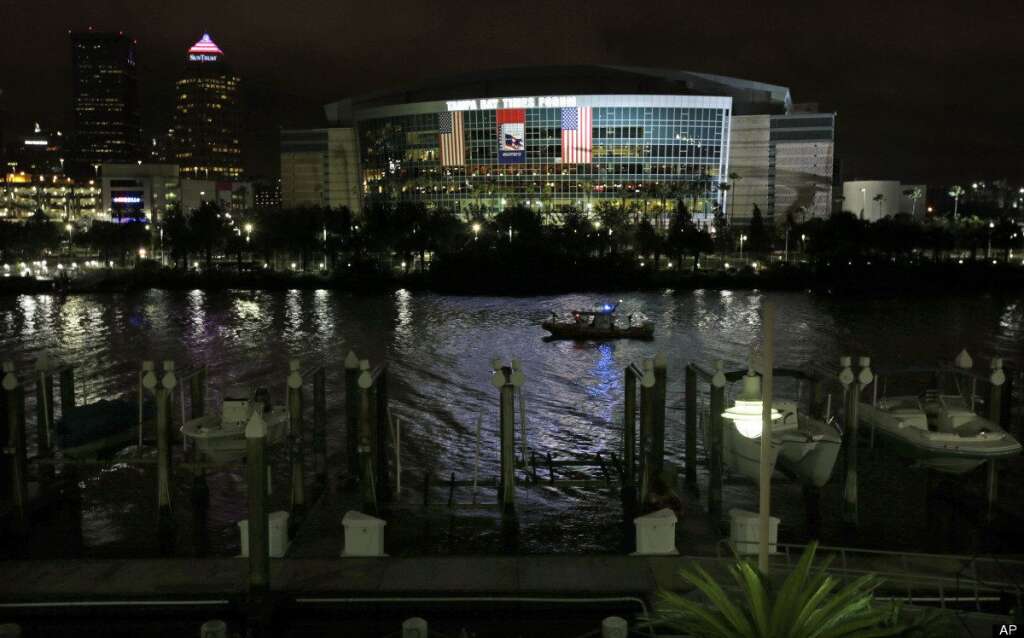 A Coast Guard patrol boat cruises past the Tampa Bay Times Forum in Tampa, Fla., Monday, Aug. 27, 2012. The start of the Republican National Convention, being held at the facility, has been delayed because of the approaching tropical storm Isaac. (AP Photo/Dave Martin)